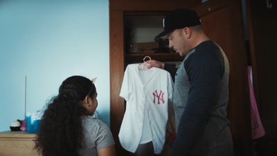 a man and a woman looking at a t - shirt