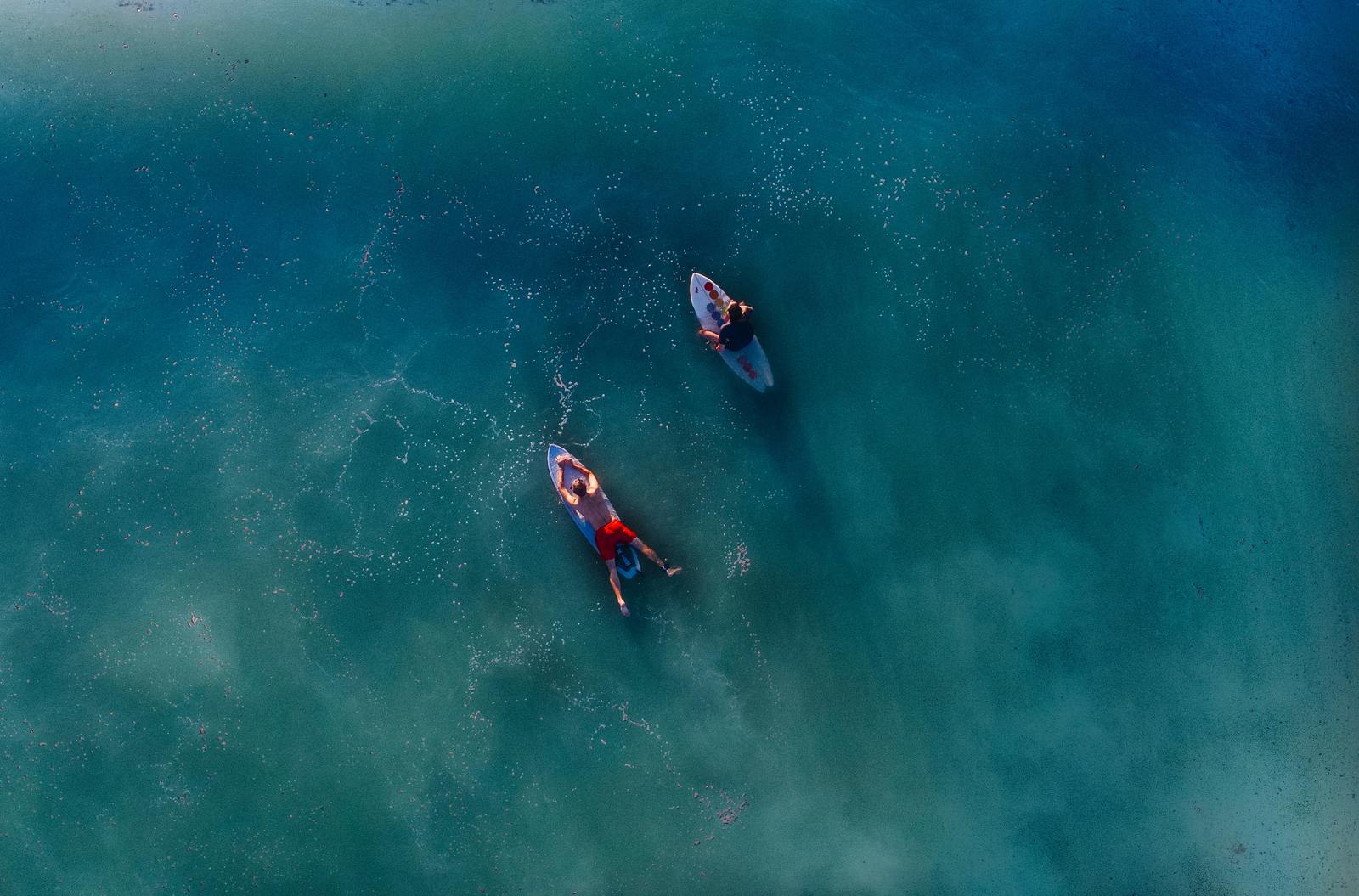 a couple of boats floating on top of a body of water