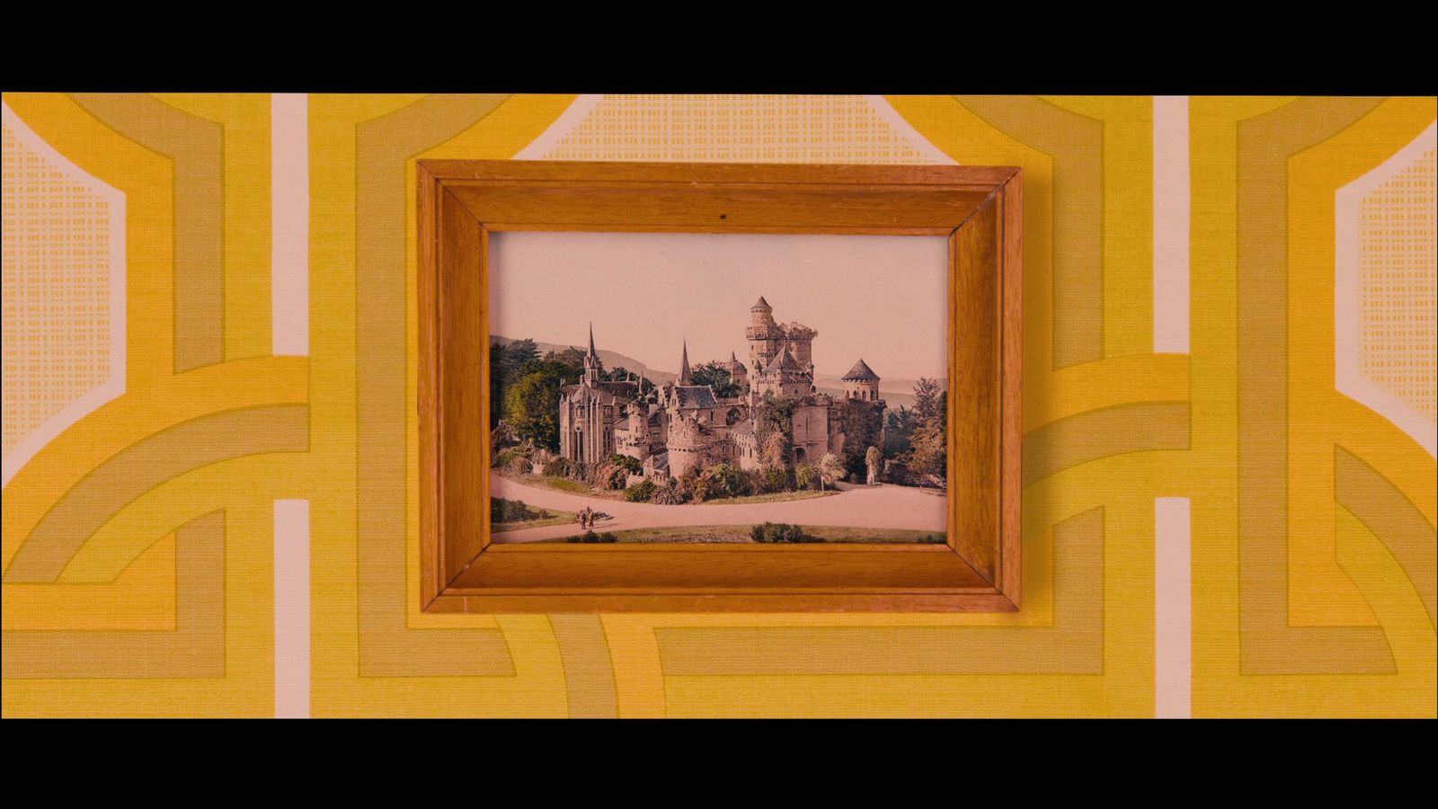 a picture of a castle in a frame on a wall