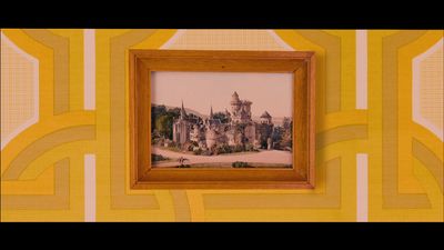 a picture of a castle in a frame on a wall