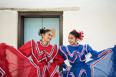 two women in colorful dresses standing next to each other