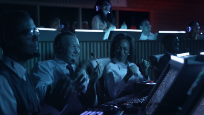 a group of people sitting in front of computers