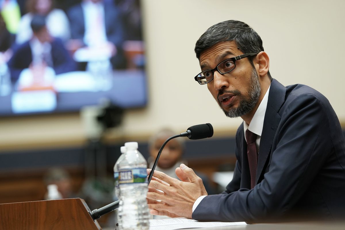 a man sitting at a table in front of a microphone