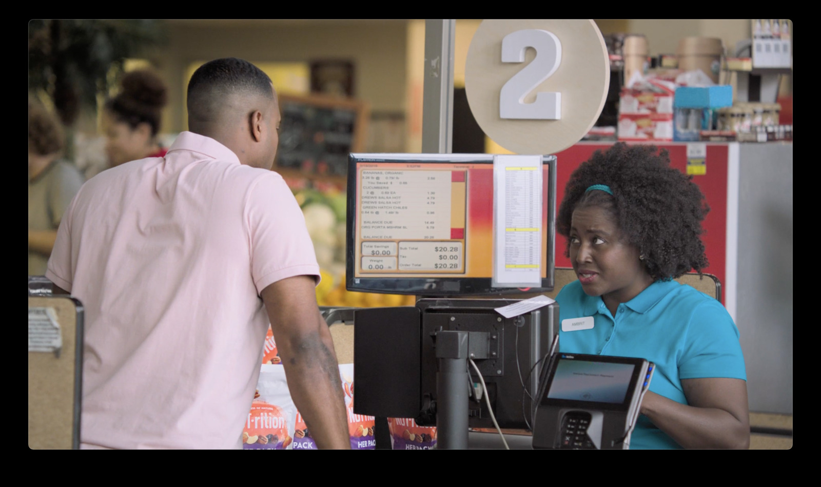 a man and a woman standing in front of a cash register