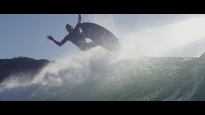 a man riding a wave on top of a surfboard