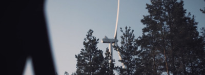 a plane flying over a forest of trees