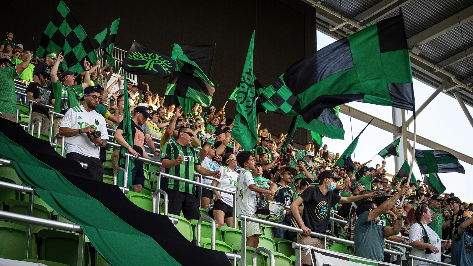 a crowd of people standing next to each other at a soccer game