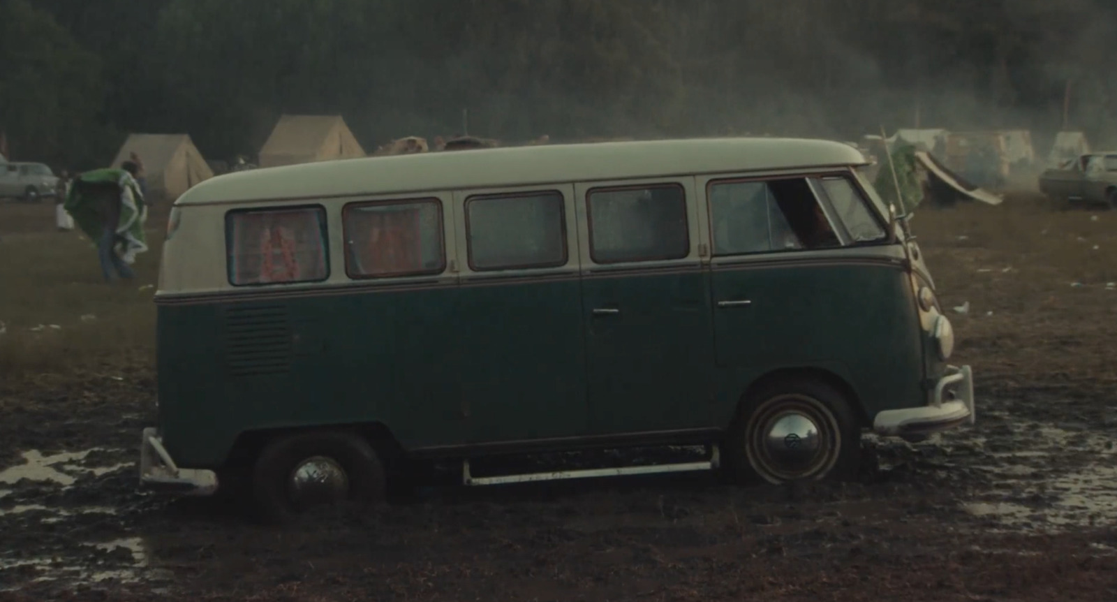 a van is parked in a muddy field