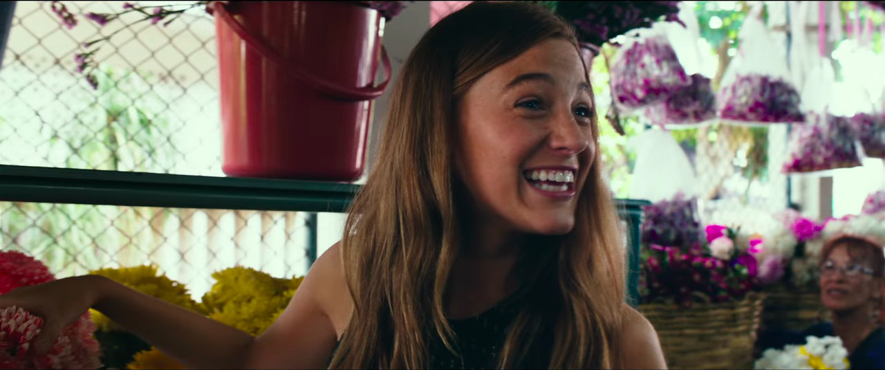 a woman is smiling in a flower shop