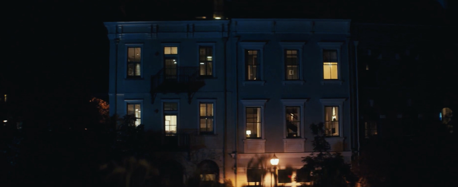 a large white building with windows lit up at night