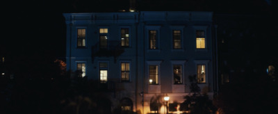 a large white building with windows lit up at night