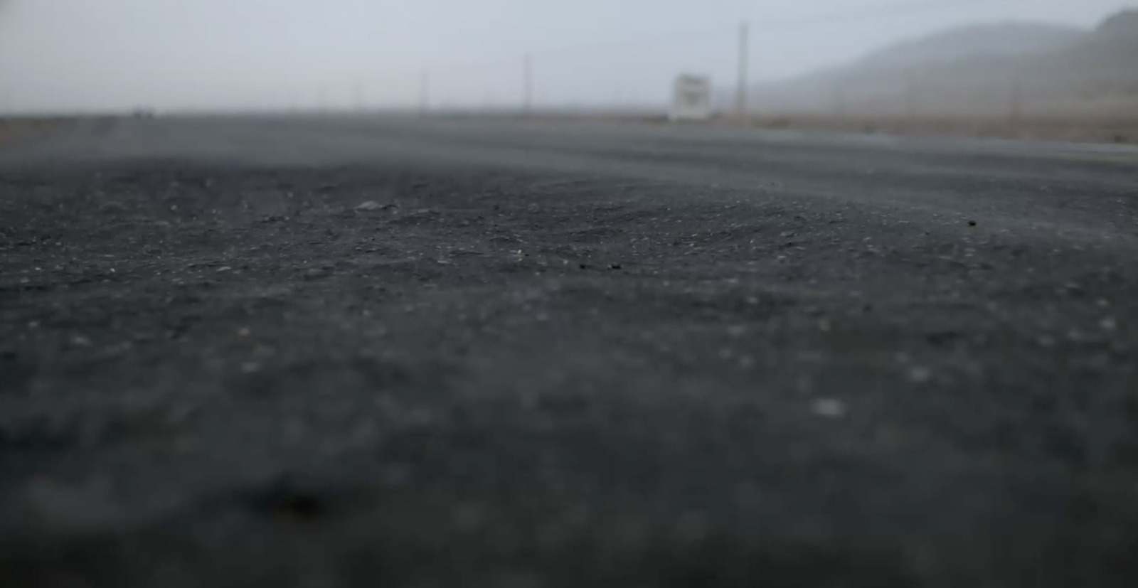 a blurry photo of an empty road in the fog