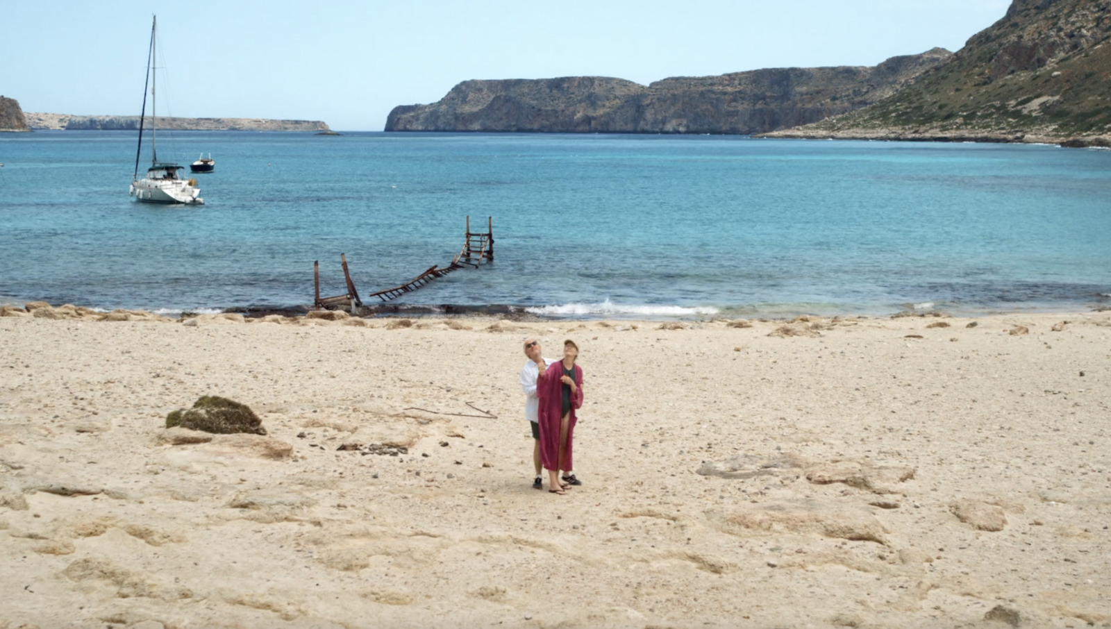 a woman standing on top of a sandy beach