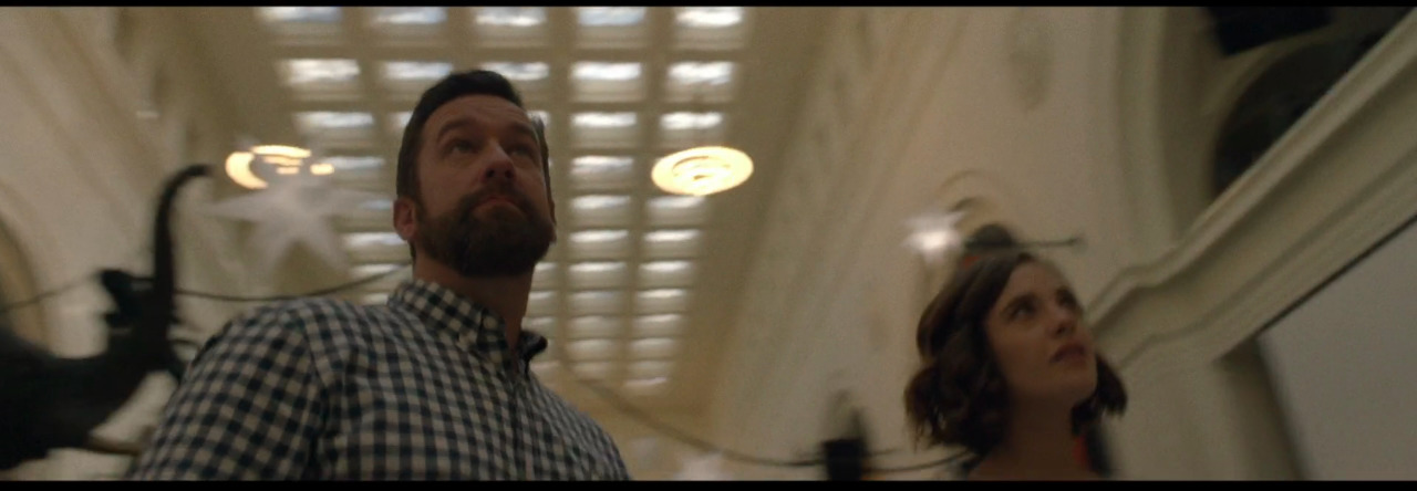 a man standing next to a woman in a room