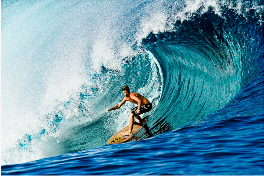 a man riding a wave on top of a surfboard