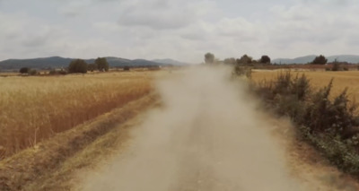 a dirt road in the middle of a wheat field