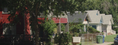 a row of houses with a car parked in front of them