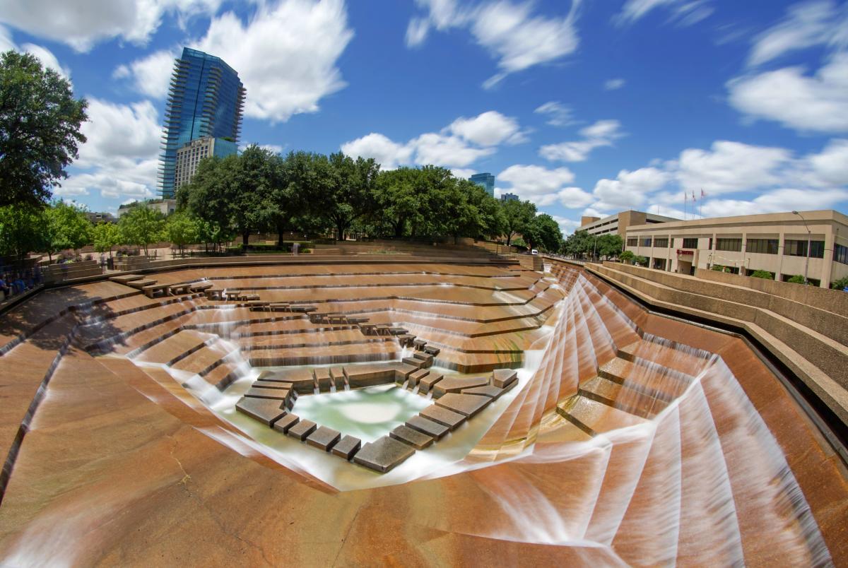 a large open area with benches and a waterfall