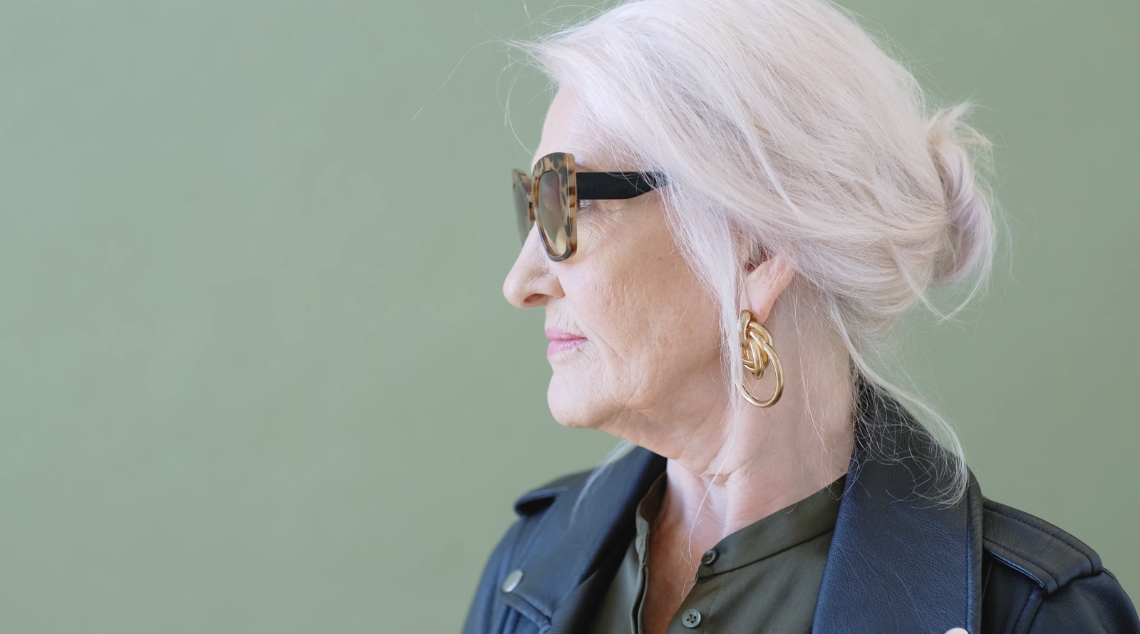 an older woman with white hair wearing sunglasses