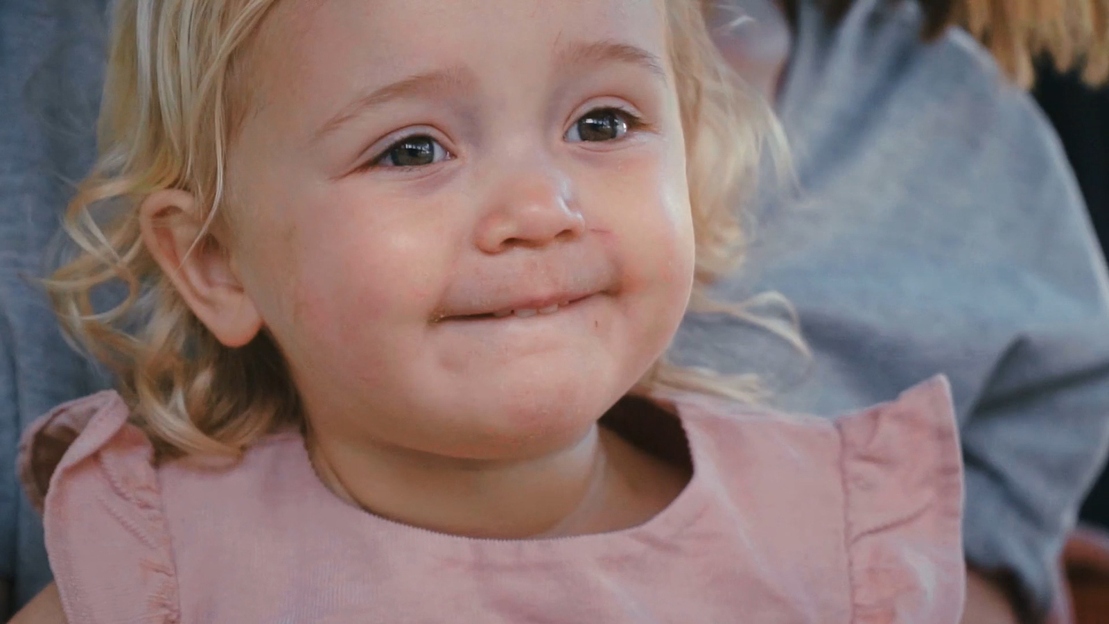 a little girl with a toothbrush in her mouth