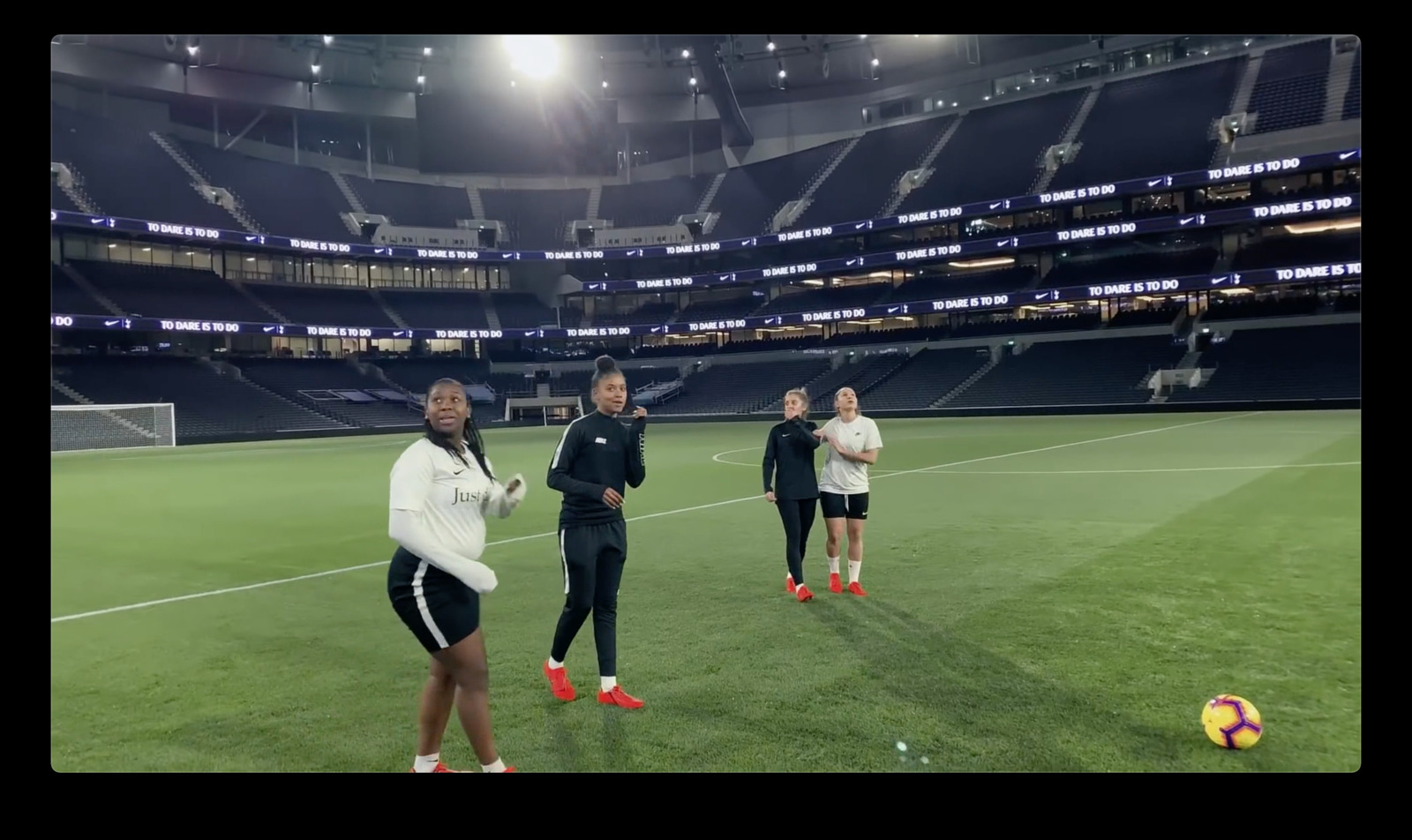 a group of women standing on top of a soccer field