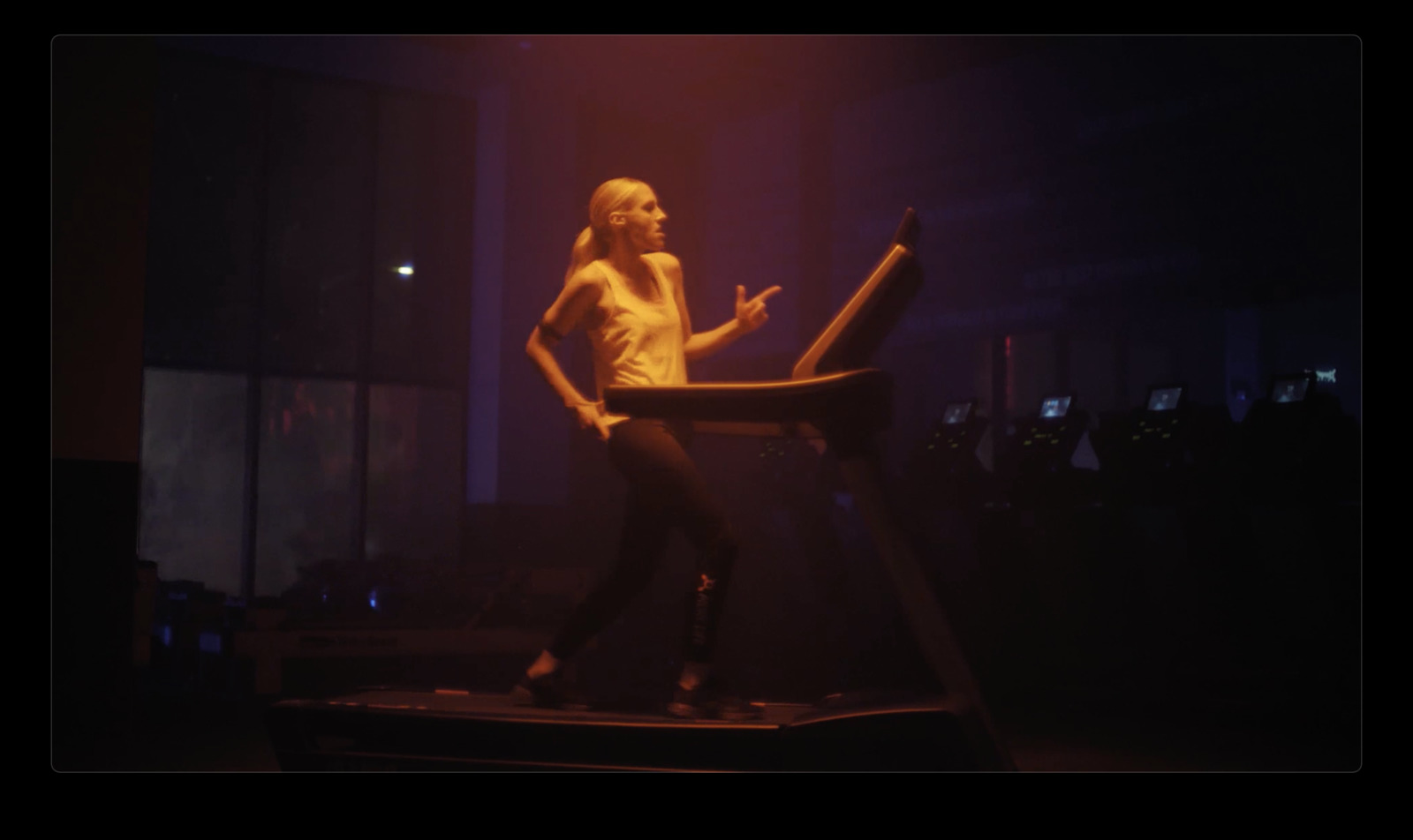 a woman standing on top of a chair in a dark room