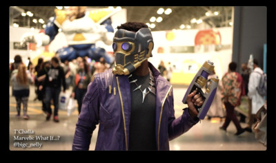 a man wearing a mask and holding a cell phone