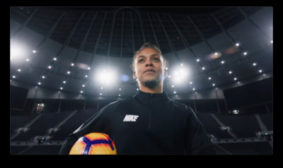 a man holding a soccer ball in a stadium