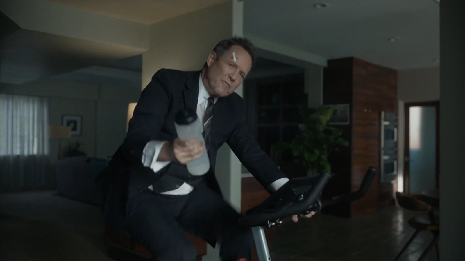 a man in a suit is riding a bike