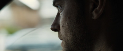 a close up of a man's face with a blurry background