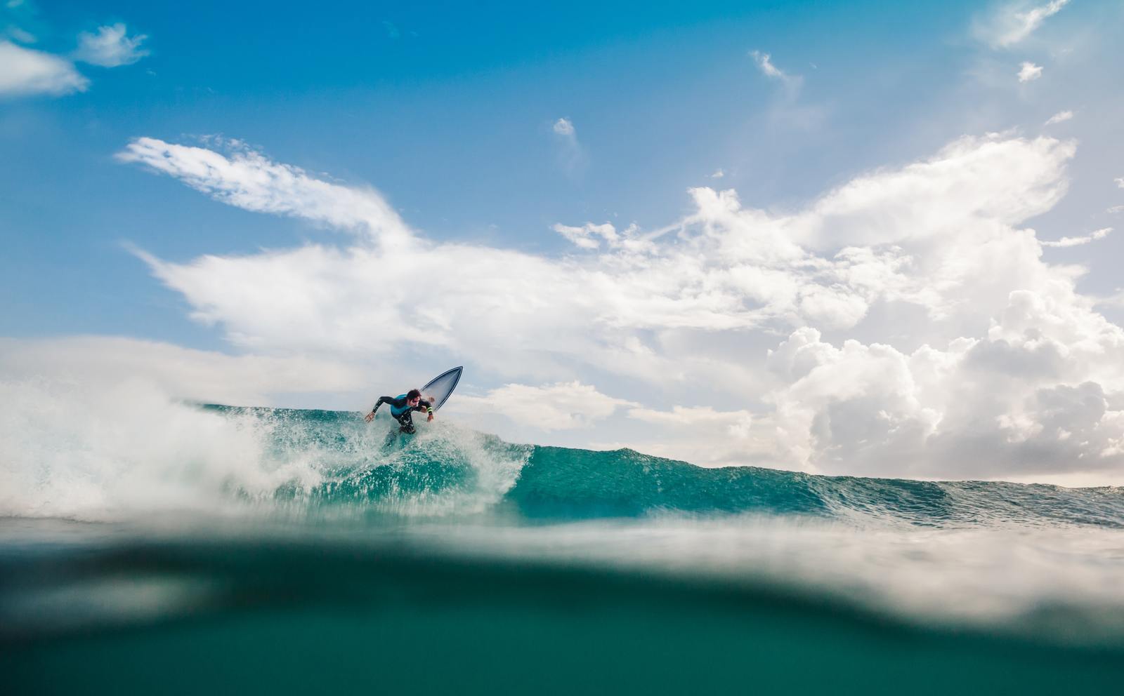 a man riding a wave on top of a surfboard