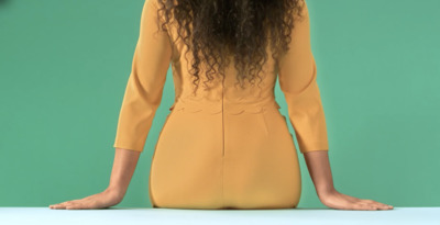 a woman with long hair sitting on a table