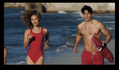 a man and a woman running on the beach