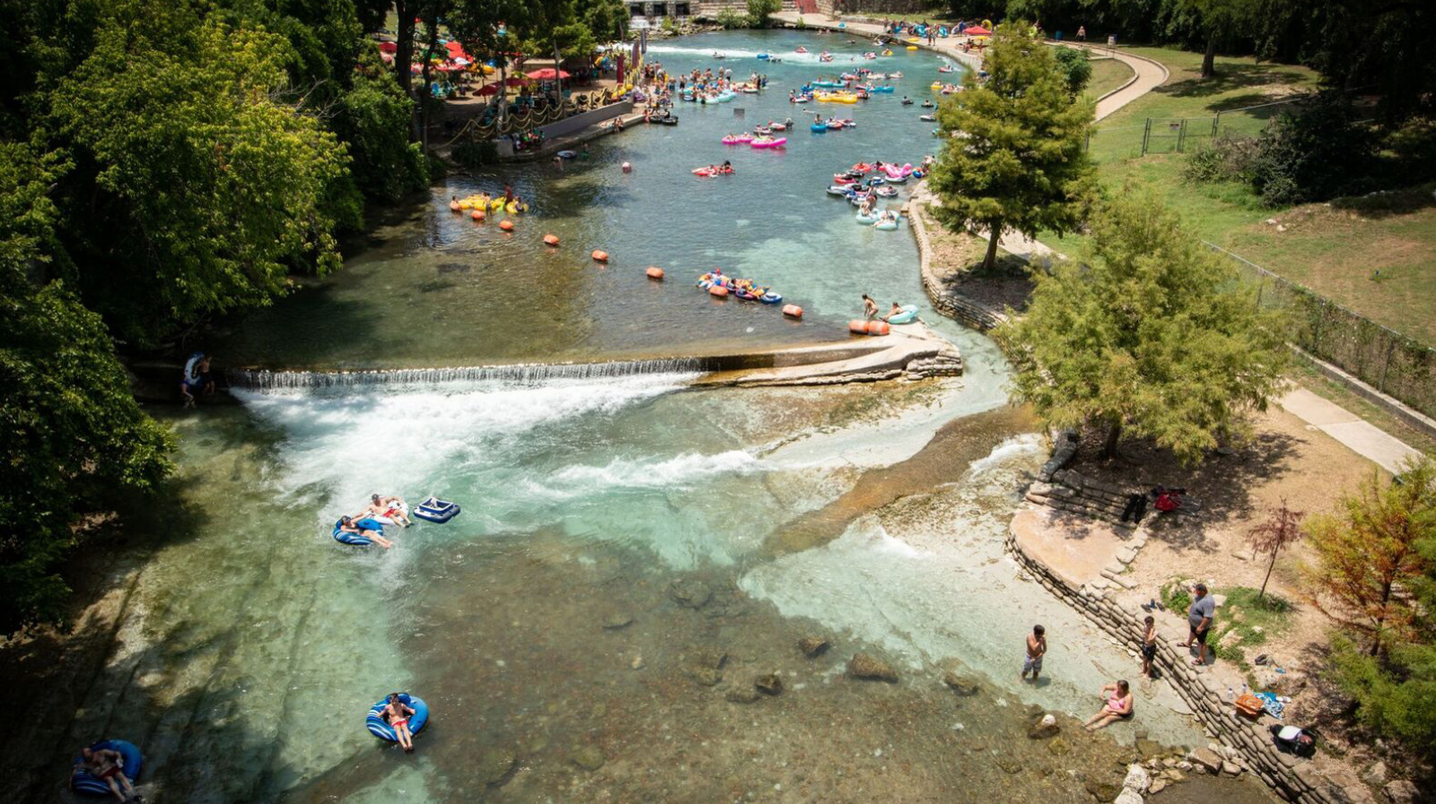 a river filled with lots of people and rafts