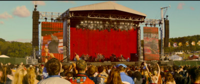 a crowd of people standing around a stage