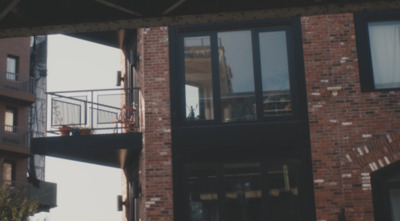 a person walking across a bridge over a street