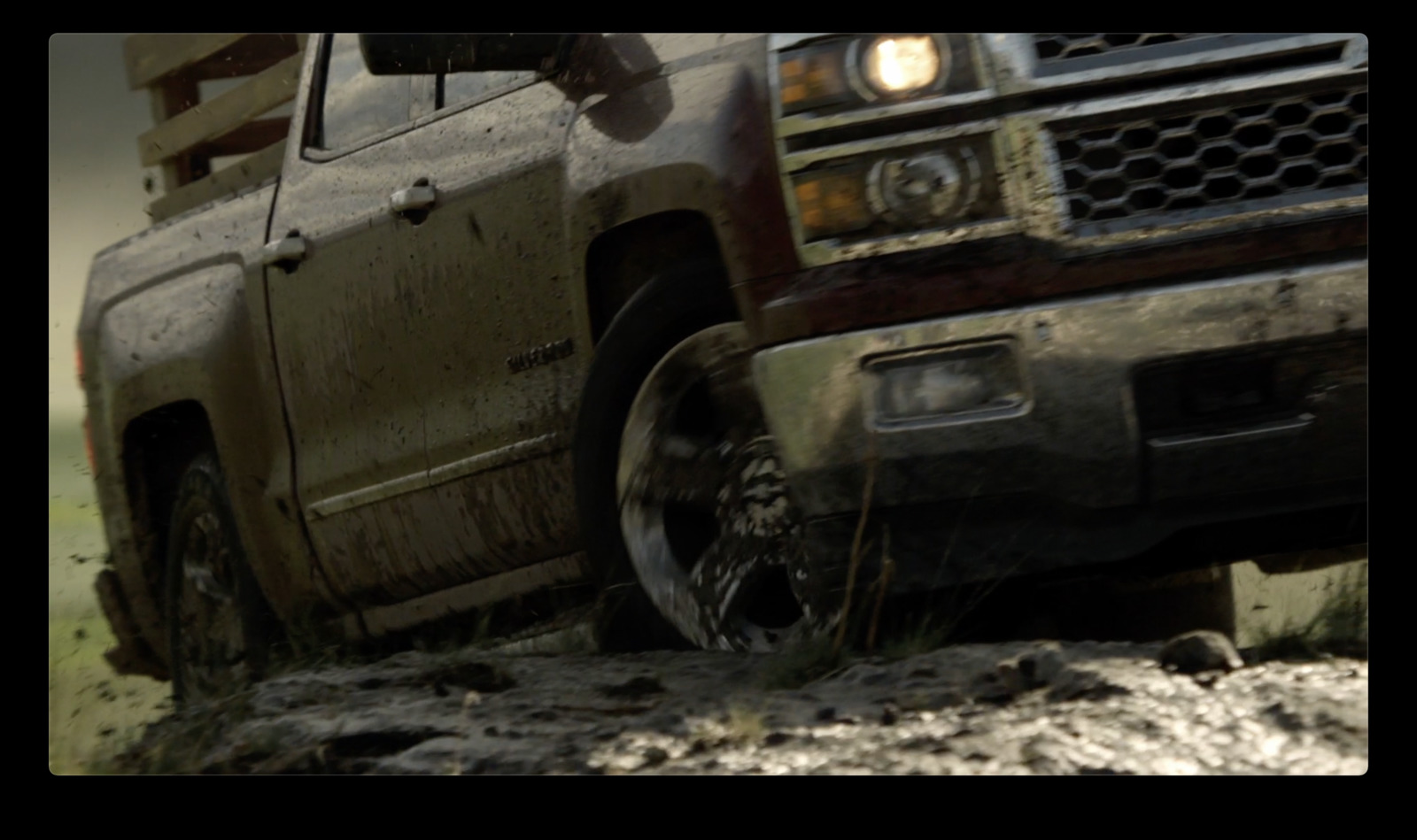 a truck is driving through a muddy field