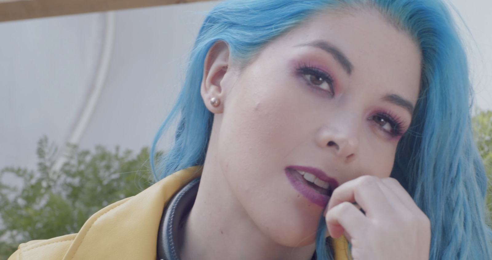 a close up of a person with blue hair