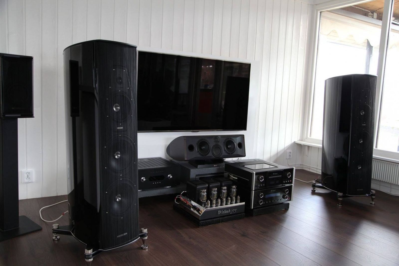 a living room with speakers and a television