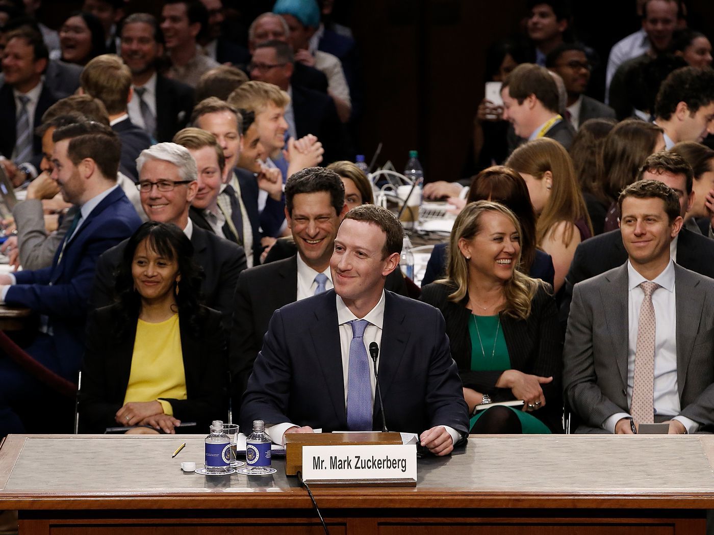 a group of people sitting in front of a table