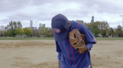 a baseball player in a blue uniform holding a catchers mitt