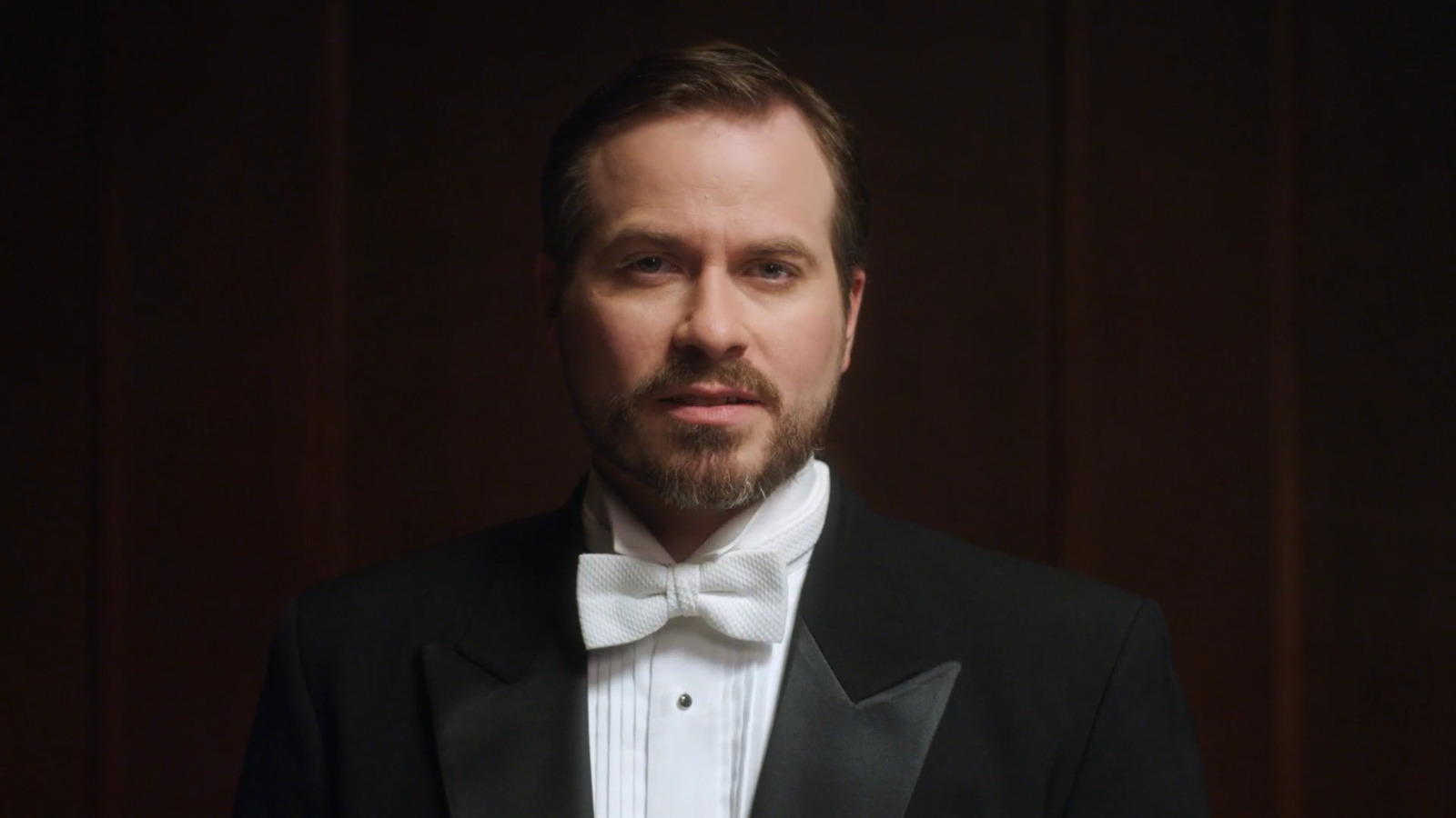 a man wearing a tuxedo and a bow tie