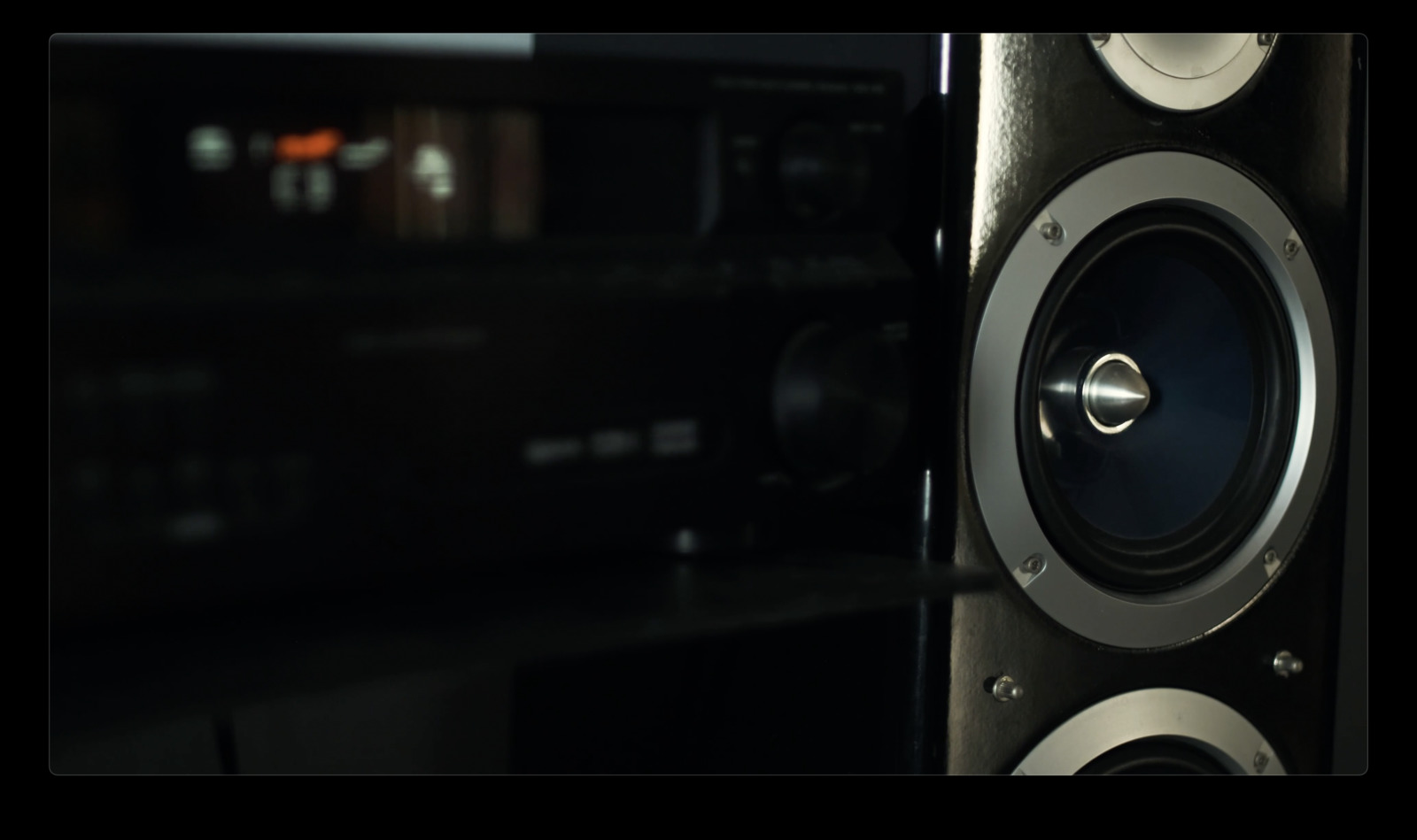 a close up of a speaker in a dark room