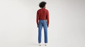 a man standing in front of a white wall