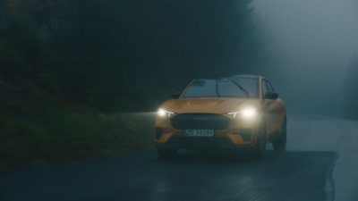 a car driving on a road in the fog