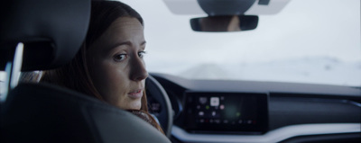 a woman sitting in a car looking out the window