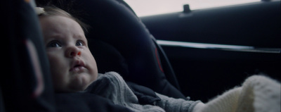 a small child sitting in a car seat