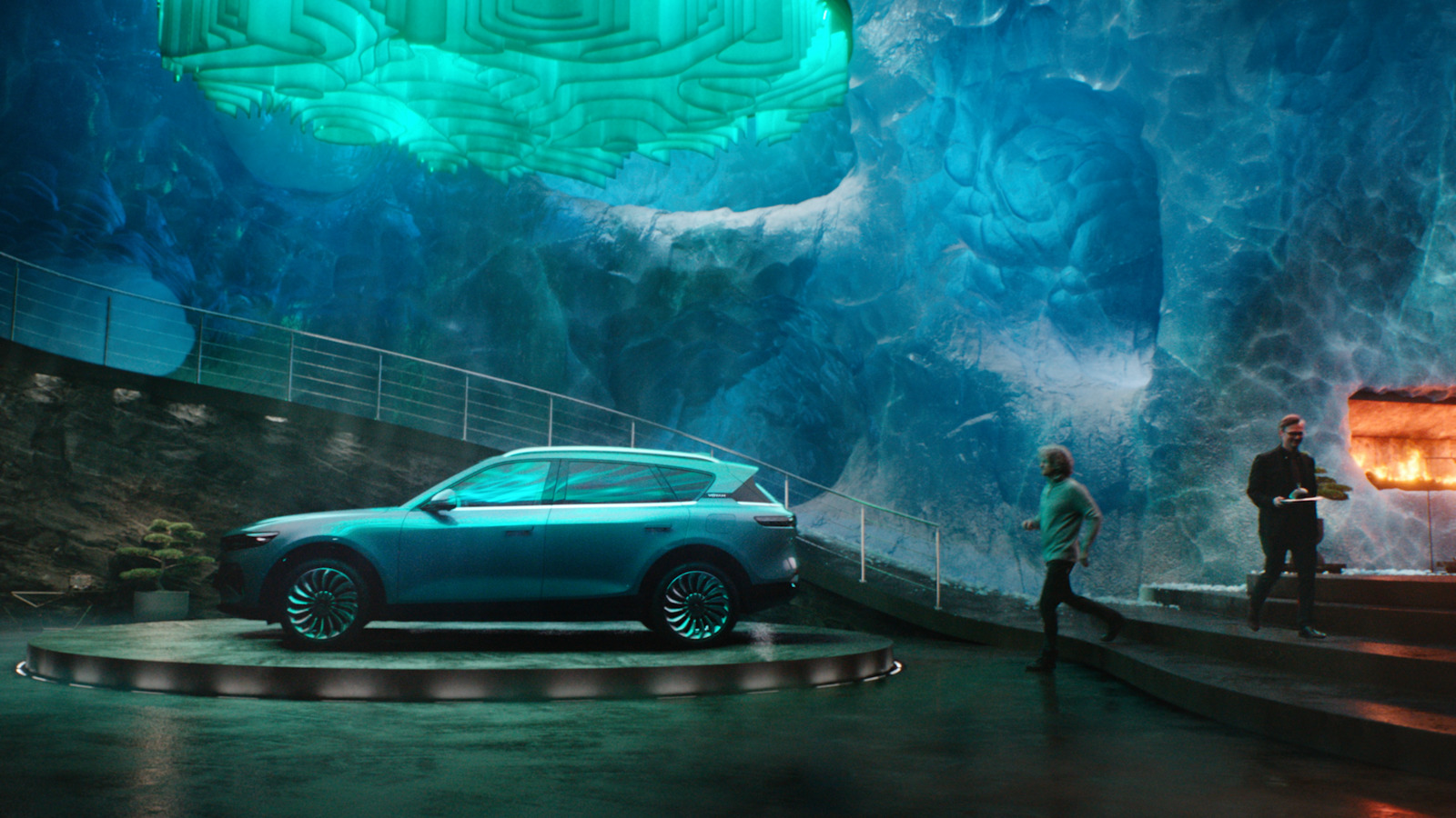 a blue car parked in front of a giant ice cave