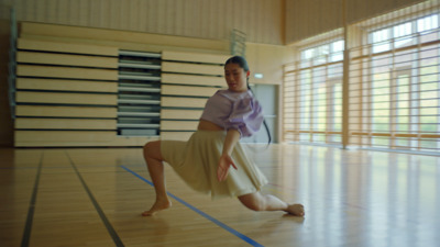 a woman is dancing on a hard wood floor