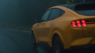 a yellow sports car driving down a road